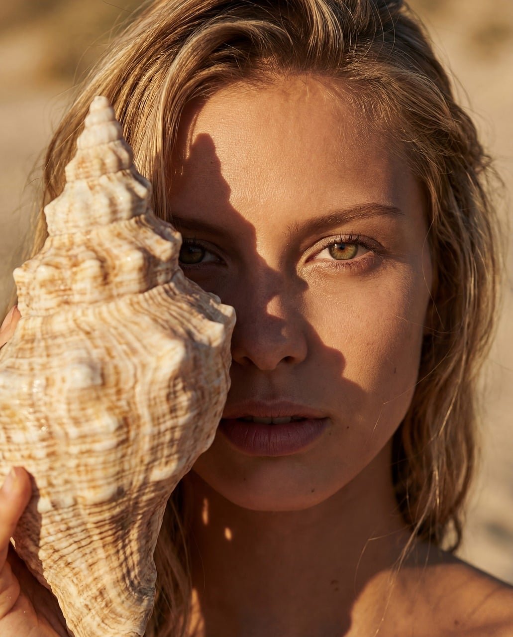 woman, seashell, beach, summer, portrait, green eyes, blonde, golden hour, sunset, nature, beauty, ocean, coast, vacation, skincare, natural, conch, sea, sand, travel, lifestyle, sunlight, close-up, tropical, marine, outdoor
